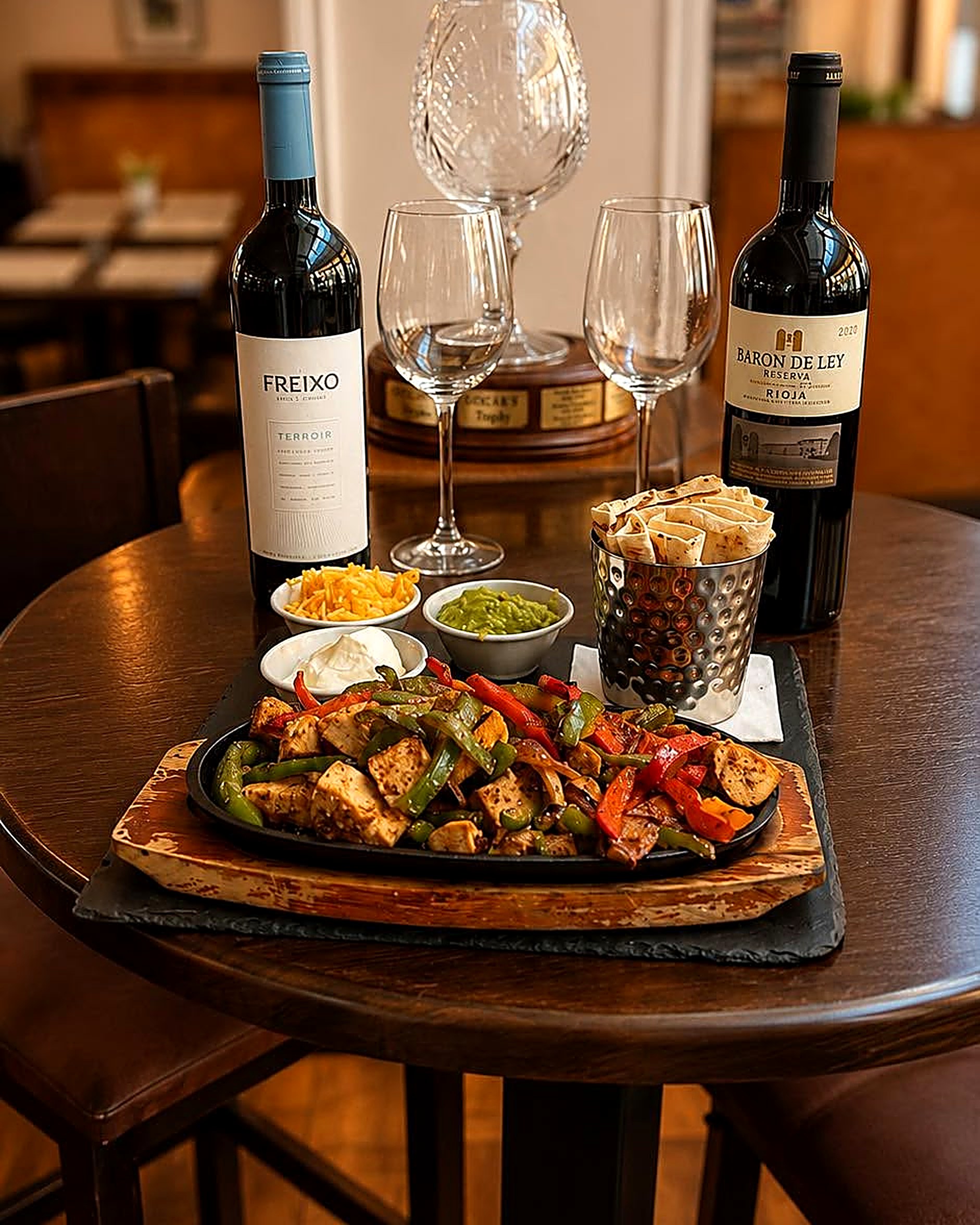 Sizzling chicken fajitas with guacamole, sour cream and warm tortillas